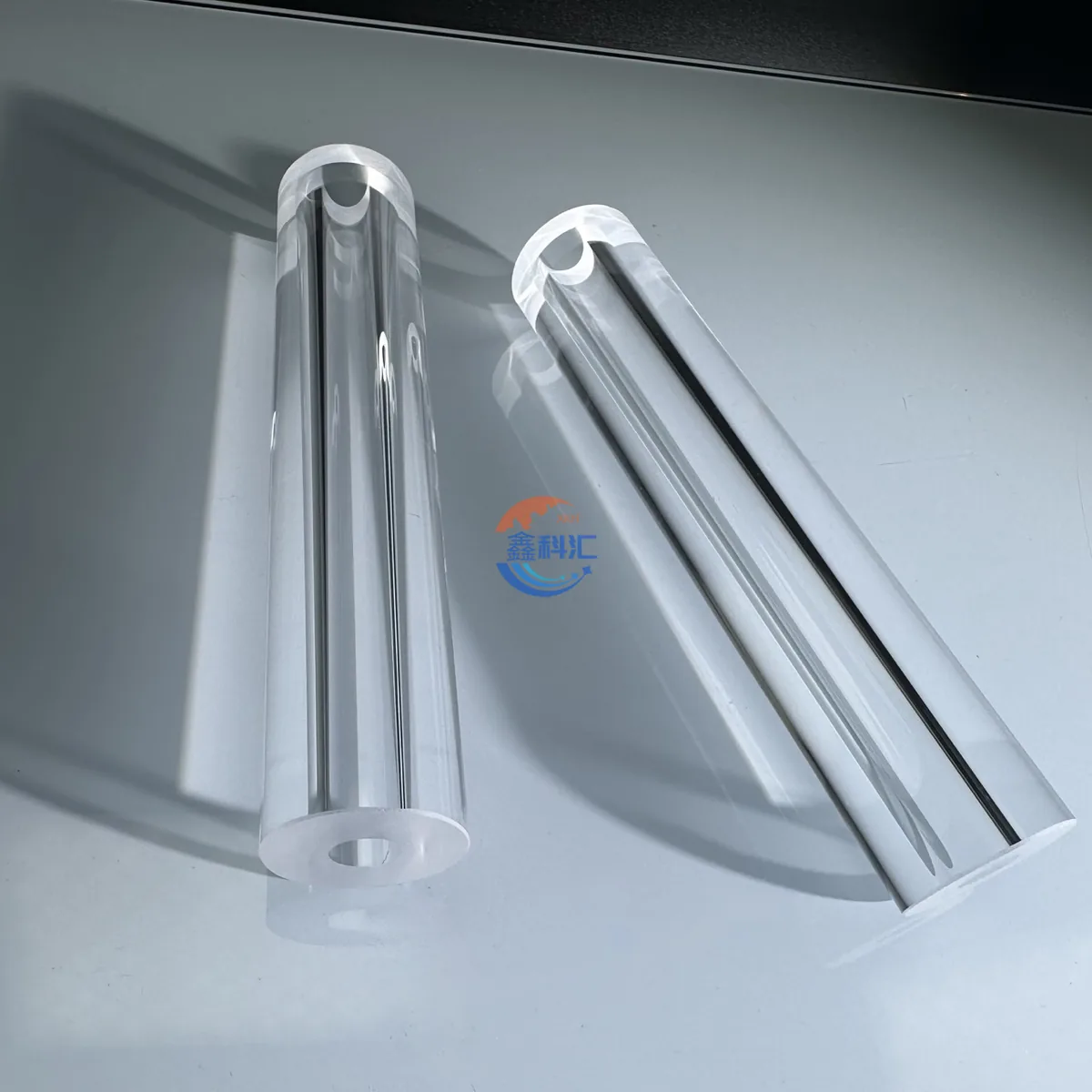 Two long transparent sapphire tubes with polished open ends
