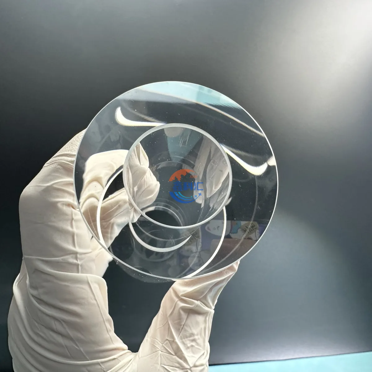 Gloved inspection of a sapphire tube cross section and transparent wall